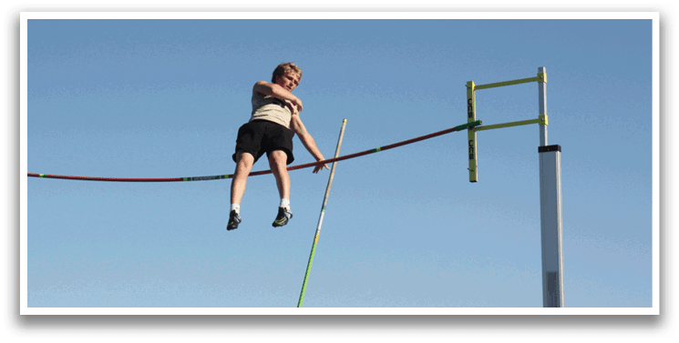 A person is jumping over a pole in a field. Contenido generado con IA