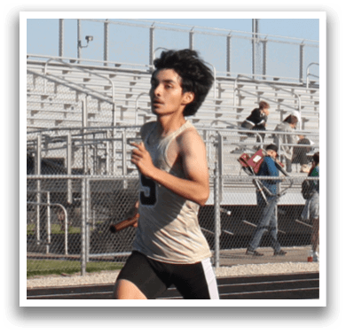 A man is running on a track, wearing a white shirt and black shorts. Contenido generado con IA