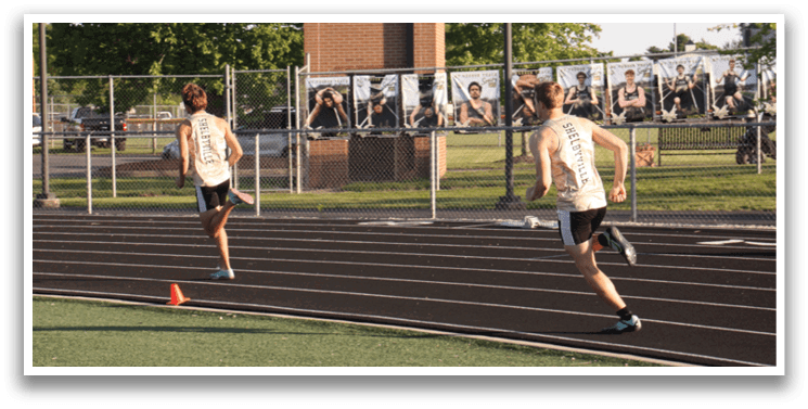 A man is running on a track in front of a crowd of people. Contenido generado con IA