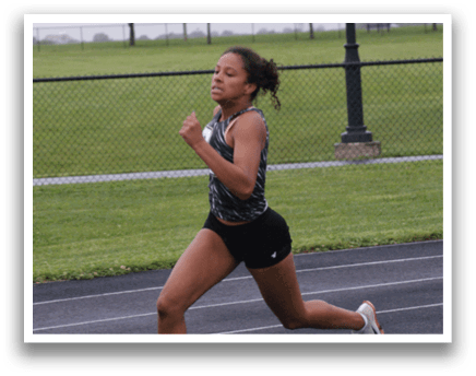 A woman is running on a track, wearing a black and white outfit. Contenido generado con IA