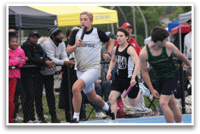 A group of people are watching a boy run on a track. Contenido generado con IA