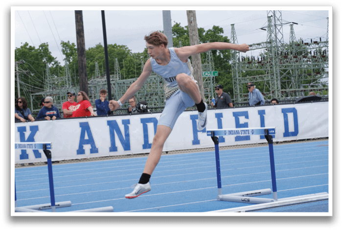 A man is jumping over a hurdle on a track. Contenido generado con IA