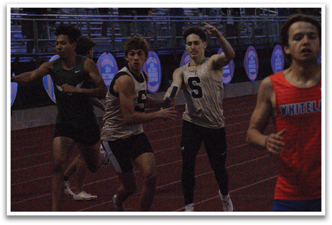 A group of young men are running on a track, with one of them wearing a red shirt. Contenido generado con IA