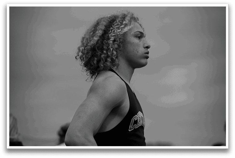 A man with long hair and a black shirt. Description generated by AI