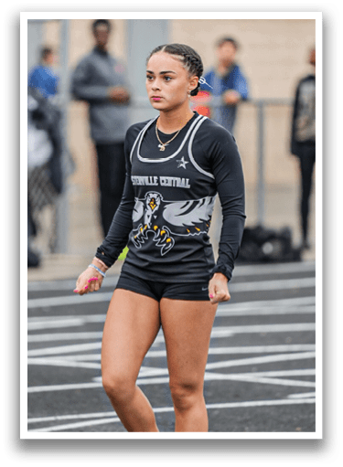 A woman wearing a black and white shirt and shorts is walking on a track. Description generated by AI