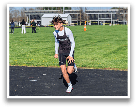 A boy running on a track. Description generated by AI