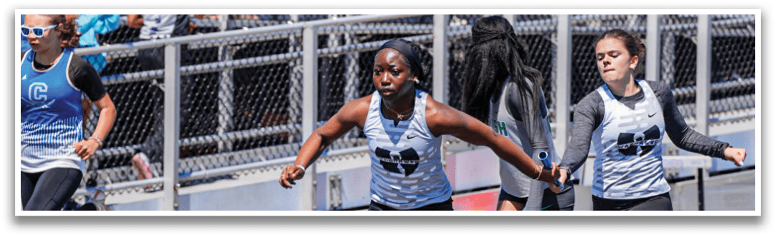 A woman is on the ground in front of a line. Description generated by AI