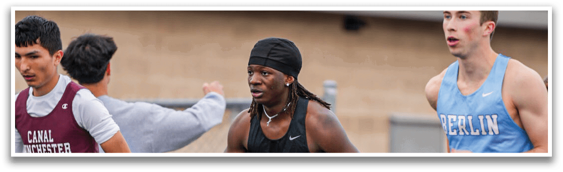 A group of people running on a track. Description generated by AI