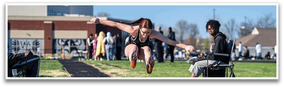 A woman is jumping in the air. Description generated by AI