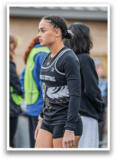 A woman wearing a black and white shirt with a bird on it. Description generated by AI