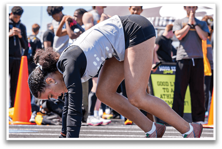 A woman bends over to pick up a blue object. Description generated by AI