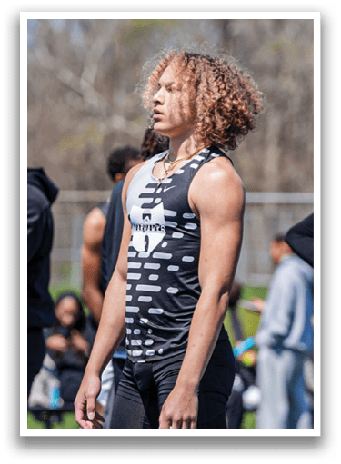A man wearing a black and white shirt and shorts. Description generated by AI
