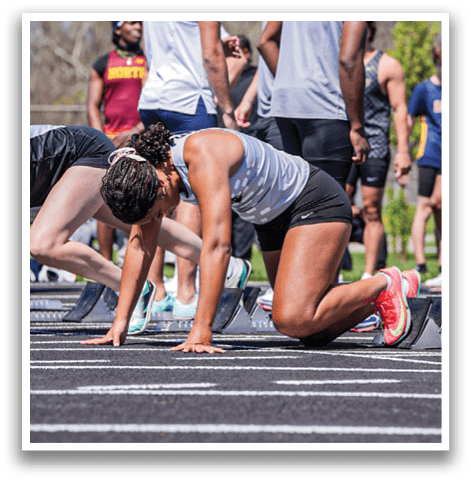 A group of people running on a track. Description generated by AI