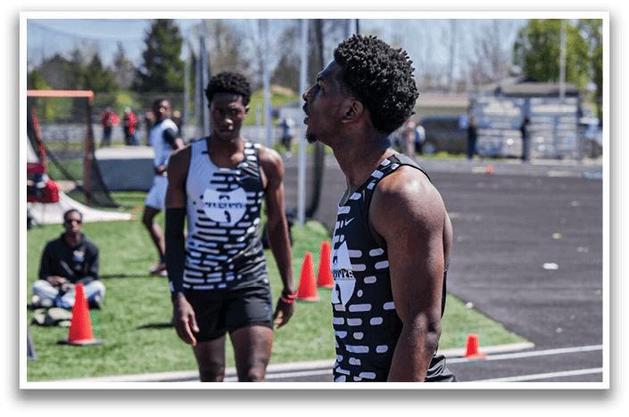 Two men are running on a track. Description generated by AI