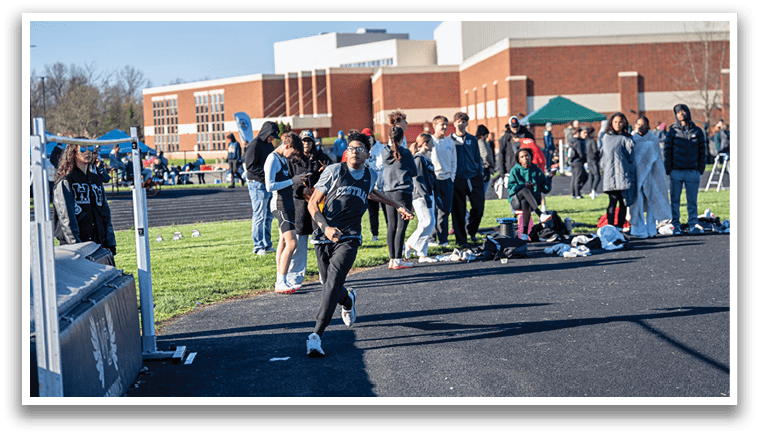 A group of people are standing on a sidewalk. Description generated by AI