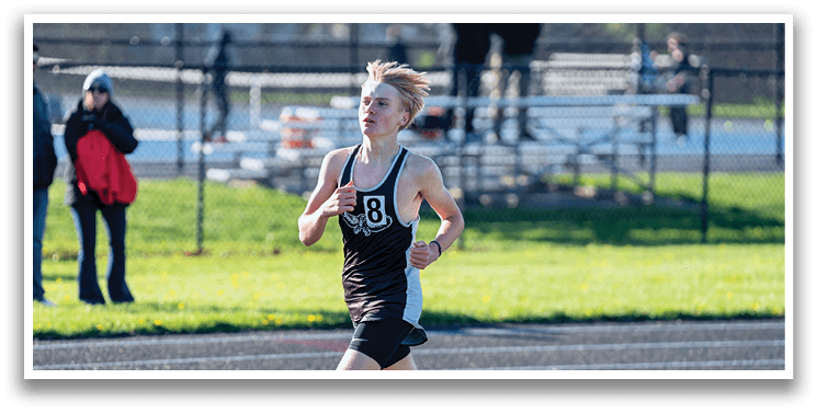 A boy running on a track. Description generated by AI