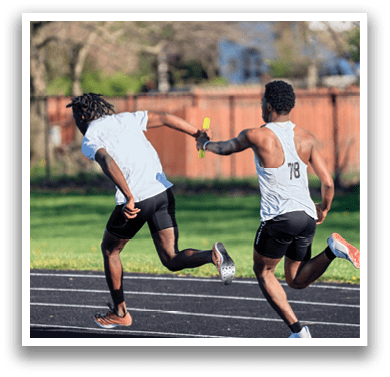 Two men running on a track. Description generated by AI