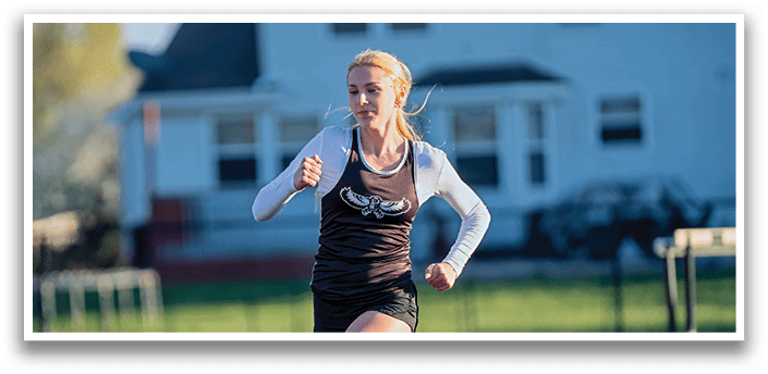 A woman running on a track. Description generated by AI