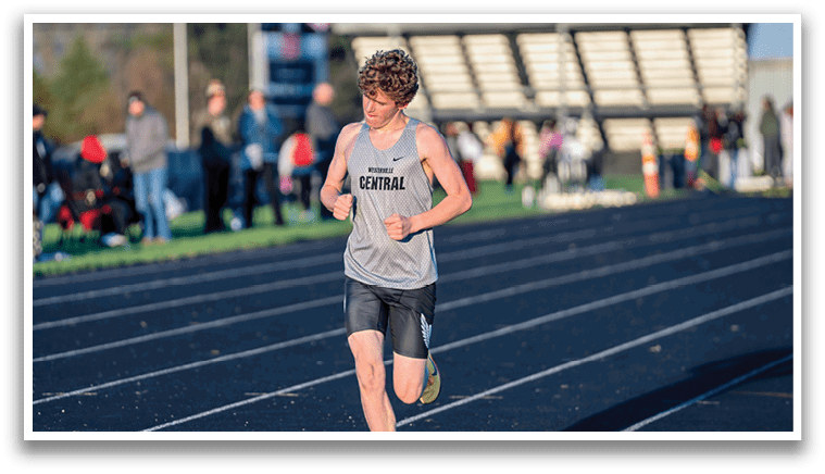 A man running on a track. Description generated by AI