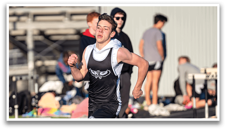 A boy running on a track. Description generated by AI