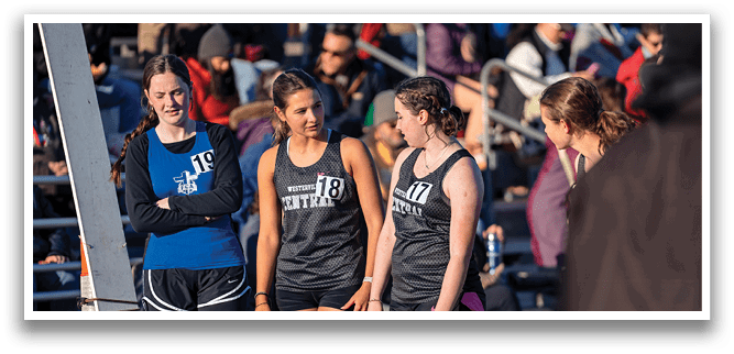 Three women wearing black and white uniforms. Description generated by AI