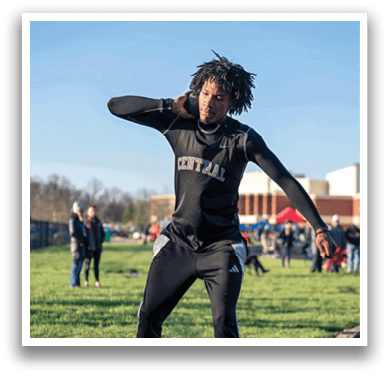 A man in a black shirt and black pants is holding a cell phone to his ear. Description generated by AI