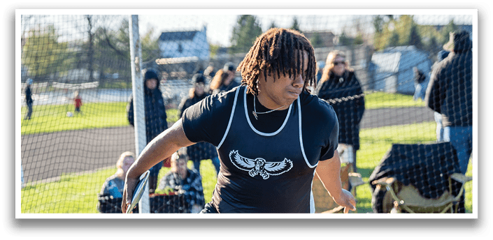 A man wearing a black shirt and black shorts is throwing a frisbee. Description generated by AI