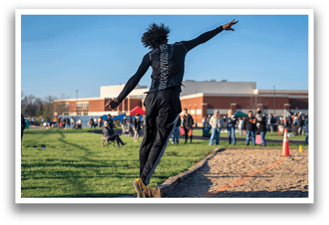 A man is jumping in the air to catch a frisbee. Description generated by AI