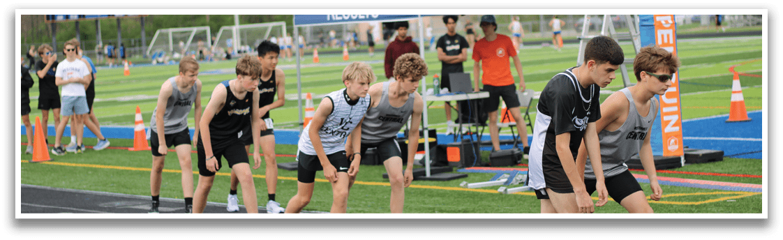 A group of young boys running on a track. Description generated by AI