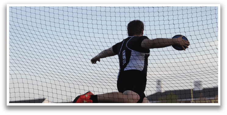 A man wearing black and white is jumping in the air to catch a frisbee. Description generated by AI