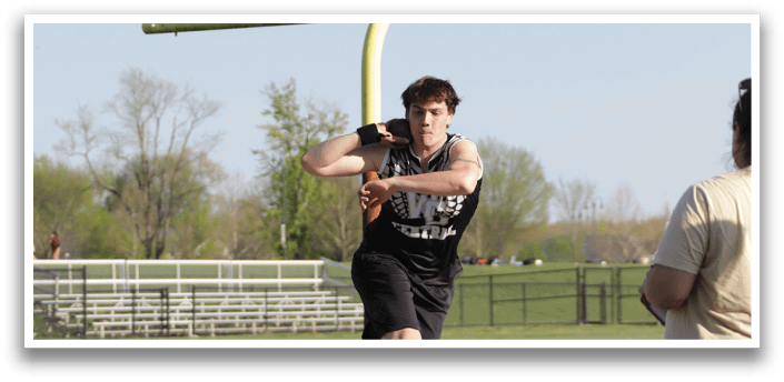 A man is throwing a football on a field. Description generated by AI