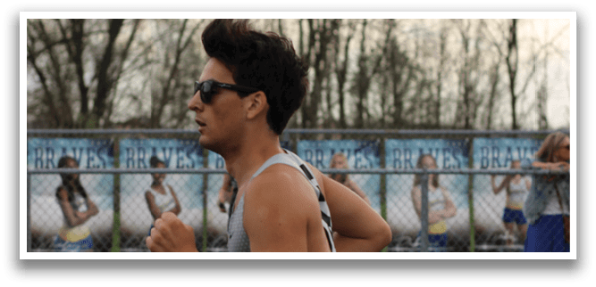 A man running on a track. Description generated by AI