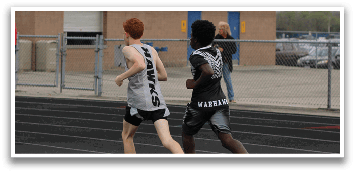 Two people running on a track. Description generated by AI
