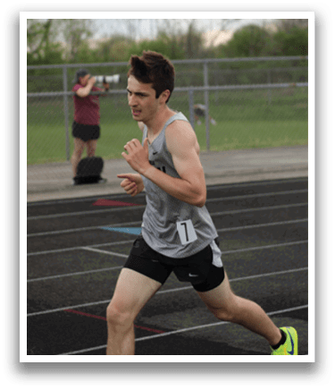A man running on a track. Description generated by AI