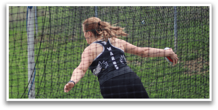 A woman is throwing a disc in a field. Description generated by AI