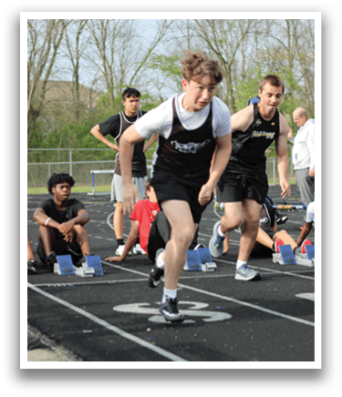 A group of people running on a track. Description generated by AI