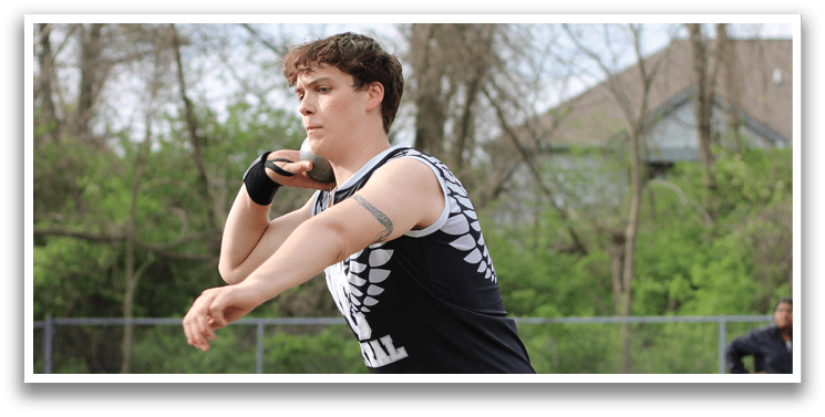 A man wearing a black shirt and shorts is throwing a disc. Description generated by AI