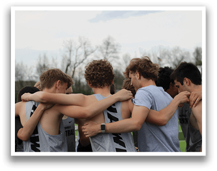 A group of people wearing gray and black shirts hugging each other. Description generated by AI