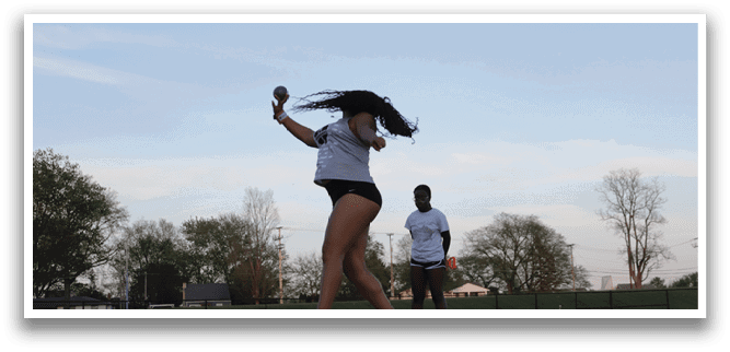 A woman is playing frisbee in a field. Description generated by AI
