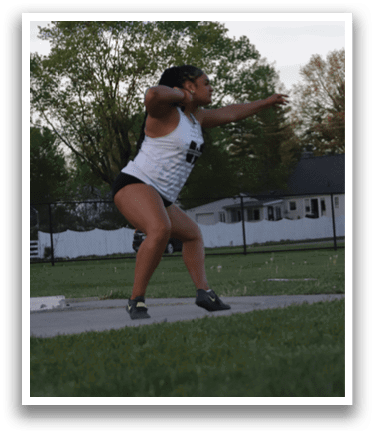 A woman is throwing a frisbee in a field. Description generated by AI