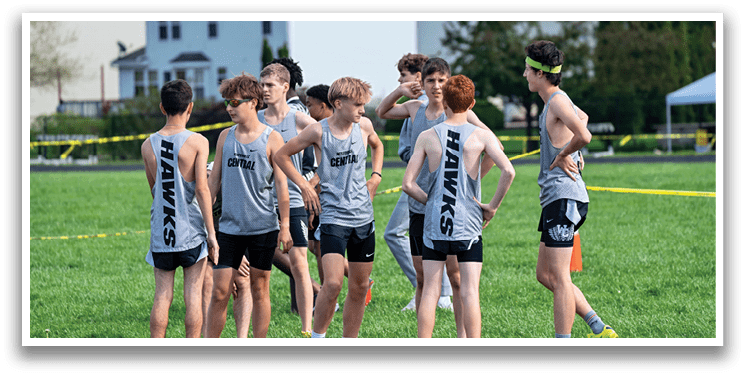 A group of young men wearing gray and black shirts and black shorts. Description generated by AI