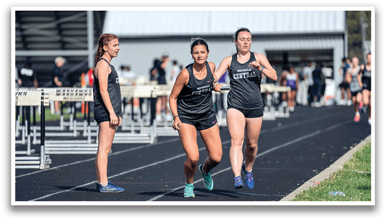 A group of girls running on a track. Description generated by AI