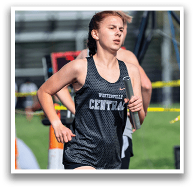 A girl running in a black and white shirt. Description generated by AI