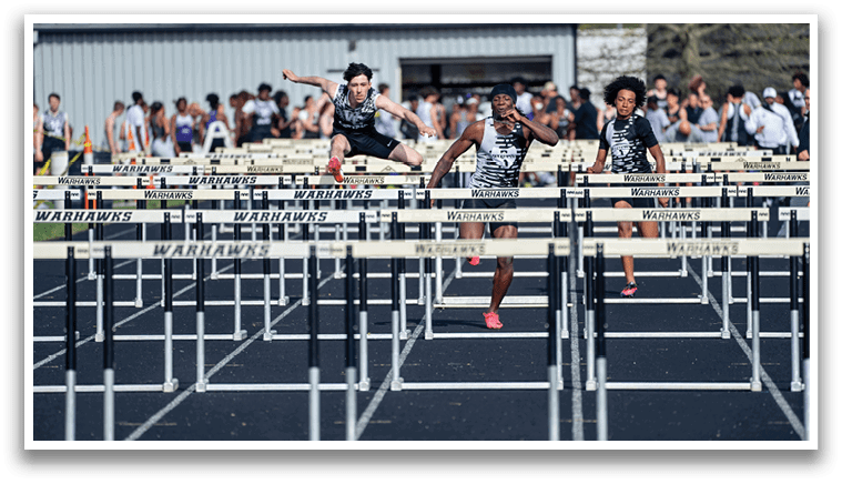 A group of people jumping over a barrier. Description generated by AI