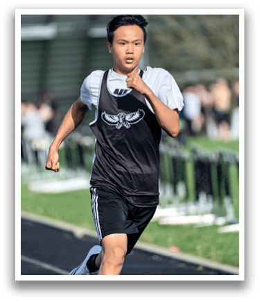 A boy running on a track. Description generated by AI