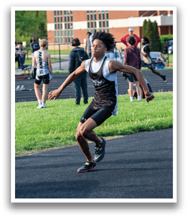 A man is jumping in a field. Description generated by AI