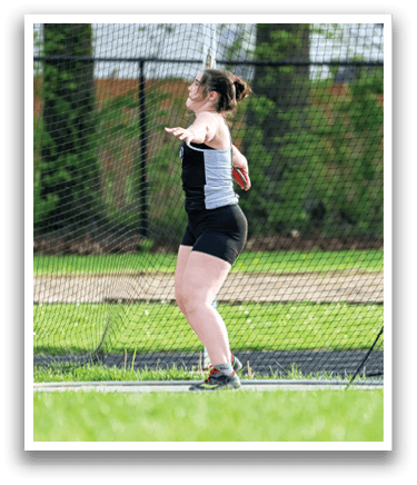 A woman is throwing a frisbee in a grassy field. Description generated by AI