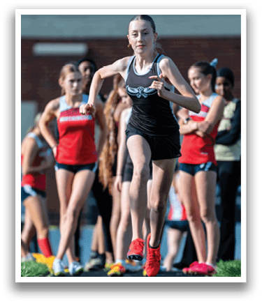 A group of girls running on a track. Description generated by AI