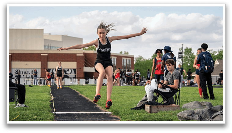 A girl is jumping in the air. Description generated by AI