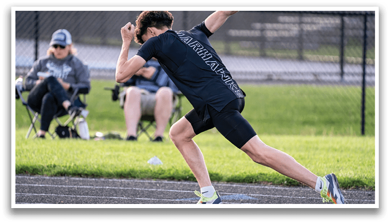 A man running on a track. Description generated by AI